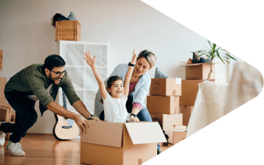 משפחה מחייכת בסלון הדירה עם ארגזים ברקע A Smiling Family in the Apartment Living Room with Boxes in the Background